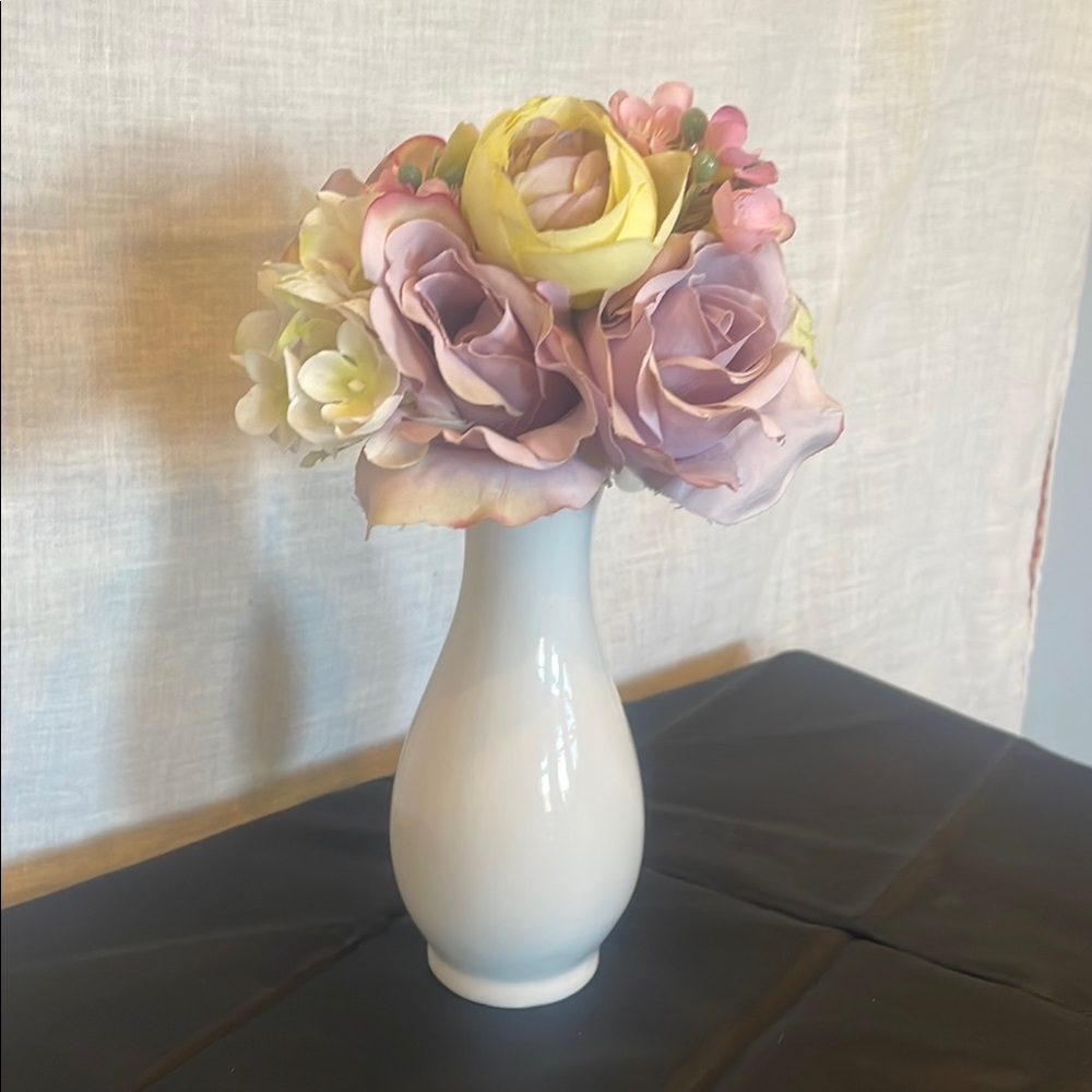 White small vase with lavendar and yellow flowers